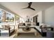 Covered patio features travertine tile, outdoor seating, and a ceiling fan at 9900 N 52Nd St, Paradise Valley, AZ 85253