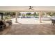 Covered patio with travertine tile flooring, ample seating, wet bar, and a view of the pool at 9900 N 52Nd St, Paradise Valley, AZ 85253
