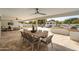 Travertine patio featuring an outdoor kitchen, dining table, and lounge area with pool views at 9900 N 52Nd St, Paradise Valley, AZ 85253