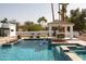 Beautiful pool featuring a tiled spa, waterfall feature, and a covered cabana for relaxing poolside at 9900 N 52Nd St, Paradise Valley, AZ 85253
