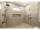 Walk in shower with a small window and bronze fixtures at 9900 N 52Nd St, Paradise Valley, AZ 85253