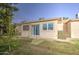 Picture of home's back exterior including a backyard with green grass and mature trees at 1021 S Greenfield Rd # 1178, Mesa, AZ 85206