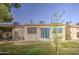 View of the home's exterior from the backyard patio with green grass and blue skies at 1021 S Greenfield Rd # 1178, Mesa, AZ 85206