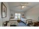 Cozy bedroom with two twin beds, a ceiling fan, and a window with blinds at 1021 S Greenfield Rd # 1178, Mesa, AZ 85206