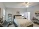Bright bedroom with a ceiling fan, a desk and a large decorative piece on the wall at 1021 S Greenfield Rd # 1178, Mesa, AZ 85206