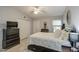 Well-lit bedroom with a ceiling fan, a TV on a dresser and a double door closet at 1021 S Greenfield Rd # 1178, Mesa, AZ 85206