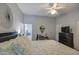 Bedroom with a ceiling fan, a dresser with a TV, and an ensuite bathroom at 1021 S Greenfield Rd # 1178, Mesa, AZ 85206
