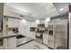 Well-lit kitchen with white cabinets, stainless steel appliances, and a sleek countertop at 1021 S Greenfield Rd # 1178, Mesa, AZ 85206
