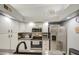 Kitchen featuring stainless appliances, white cabinetry, and modern countertops with neutral decor at 1021 S Greenfield Rd # 1178, Mesa, AZ 85206