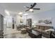 Inviting living room with skylights, ceiling fan, and open dining area filled with natural light at 1021 S Greenfield Rd # 1178, Mesa, AZ 85206