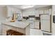 Bright kitchen featuring white cabinets, granite countertops, and a breakfast bar at 1106 S 82Nd Way, Mesa, AZ 85208