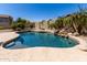 A sprawling backyard featuring a private pool surrounded by desert landscaping at 11318 S Hopi Dr, Goodyear, AZ 85338