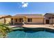 Enjoy a backyard with a pool and covered patio for outdoor entertaining in your new home at 11318 S Hopi Dr, Goodyear, AZ 85338
