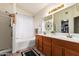 Bathroom featuring double sinks, a soaking tub, and a separate shower at 11318 S Hopi Dr, Goodyear, AZ 85338