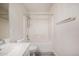 This bathroom features a single sink vanity, wood-look floors, and a shower over tub with a white tile surround at 11318 S Hopi Dr, Goodyear, AZ 85338