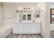 Bright bathroom with a double vanity, white cabinets, and modern lighting fixtures at 11318 S Hopi Dr, Goodyear, AZ 85338