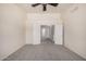 Bedroom with carpet, ceiling fan, and doorway leading to hallway at 11318 S Hopi Dr, Goodyear, AZ 85338