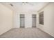Bedroom featuring two large sliding door closets and a window at 11318 S Hopi Dr, Goodyear, AZ 85338