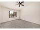 Carpeted bedroom with a ceiling fan and a view of a pond and trees at 11318 S Hopi Dr, Goodyear, AZ 85338