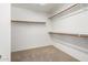 Empty walk-in closet with carpet flooring and shelving at 11318 S Hopi Dr, Goodyear, AZ 85338