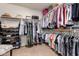 Walk-in closet with extensive shelving and hanging space for clothes and accessories at 11318 S Hopi Dr, Goodyear, AZ 85338