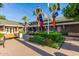 Community clubhouse with benches, manicured hedges, and flower beds at 11318 S Hopi Dr, Goodyear, AZ 85338