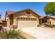 Charming single story home features a two car garage and desert landscaping at 11318 S Hopi Dr, Goodyear, AZ 85338