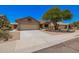 Charming single-story home with a two-car garage and low-maintenance desert landscaping at 11318 S Hopi Dr, Goodyear, AZ 85338