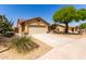 Inviting single-story home with a two-car garage and a xeriscaped front yard at 11318 S Hopi Dr, Goodyear, AZ 85338