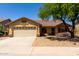 Charming single-story home with low maintenance desert landscaping and a neutral color palette at 11318 S Hopi Dr, Goodyear, AZ 85338