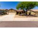 Attractive single-story home with a two-car garage and established desert landscaping at 11318 S Hopi Dr, Goodyear, AZ 85338