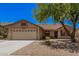 Beautiful home featuring a well-maintained yard, desert landscaping, and a two-car garage at 11318 S Hopi Dr, Goodyear, AZ 85338