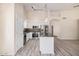 Open kitchen with stainless steel appliances, white cabinetry, a large island, and modern lighting at 11318 S Hopi Dr, Goodyear, AZ 85338