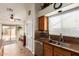 Cozy kitchen with a double sink, stainless steel dishwasher and a window with blinds at 11318 S Hopi Dr, Goodyear, AZ 85338