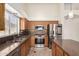 Well-lit kitchen boasts stainless steel appliances, mosaic backsplash, and ample counter space at 11318 S Hopi Dr, Goodyear, AZ 85338