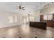 Open-concept kitchen and dining area with an island and ample natural light at 11318 S Hopi Dr, Goodyear, AZ 85338