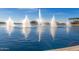 Beautiful lake view featuring fountains, landscaping, and a clear blue sky at 11318 S Hopi Dr, Goodyear, AZ 85338
