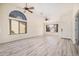 Light-filled living room with vaulted ceiling boasts modern floors, neutral paint, and ample natural light at 11318 S Hopi Dr, Goodyear, AZ 85338