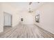 Open living room featuring neutral paint, modern flooring, and a seamless transition to other living spaces at 11318 S Hopi Dr, Goodyear, AZ 85338