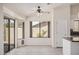 Bright living room featuring sliding doors, a fan, light-colored walls, and light wood-look flooring at 11318 S Hopi Dr, Goodyear, AZ 85338