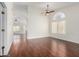 Spacious living area featuring high ceilings, hardwood floors, and an abundance of natural light at 11318 S Hopi Dr, Goodyear, AZ 85338