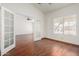 Bright living room with pristine white walls, hardwood floors, and bright natural light at 11318 S Hopi Dr, Goodyear, AZ 85338