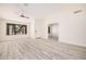 Spacious living room has wood-look floors, neutral colors, high ceilings, and access to other areas at 11318 S Hopi Dr, Goodyear, AZ 85338