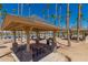 Covered picnic area featuring picnic tables, built-in barbeques and palm trees at 11318 S Hopi Dr, Goodyear, AZ 85338