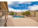 Backyard oasis with a refreshing pool, lush landscaping, and serene outdoor space at 11318 S Hopi Dr, Goodyear, AZ 85338