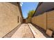 Side yard with pavers and walkway to a gate, connecting the front and back yards at 11318 S Hopi Dr, Goodyear, AZ 85338