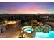 Aerial view of a backyard with a pool, spa, bar, outdoor kitchen, and desert views at 11988 E Larkspur Dr, Scottsdale, AZ 85259