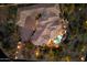 Aerial view of an expansive home with a tile roof, circular design, and a backyard pool oasis at 11988 E Larkspur Dr, Scottsdale, AZ 85259
