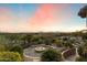 Well-manicured backyard with desert landscaping, a cozy fire pit, and panoramic views of the surrounding landscape at 11988 E Larkspur Dr, Scottsdale, AZ 85259