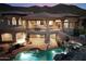 Stunning backyard with a luxurious pool, covered patio, outdoor dining area, and scenic mountain backdrop at 11988 E Larkspur Dr, Scottsdale, AZ 85259